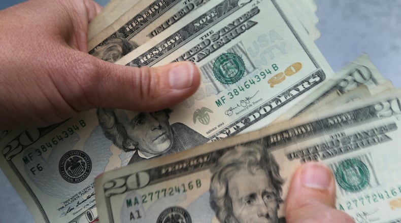 FILE - In this June 15, 2018 photo, twenty dollar bills are counted in North Andover, Mass. As the middle of the year approaches, it’s a smart time to check in on the money goals you set back in January and make any necessary adjustments. If you didn’t create goals, it’s not too late to establish them for the second half of the year. First, define or update what your goals are. (AP Photo/Elise Amendola, File)