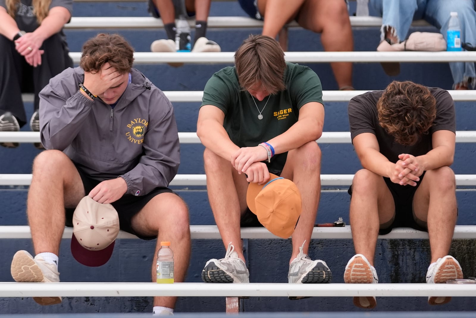 Attendees react during a vigil for flooding victims at Tivy Antler Stadium on Wednesday, July 9, 2025, in Kerrville, Texas. (AP Photo/Gerald Herbert)