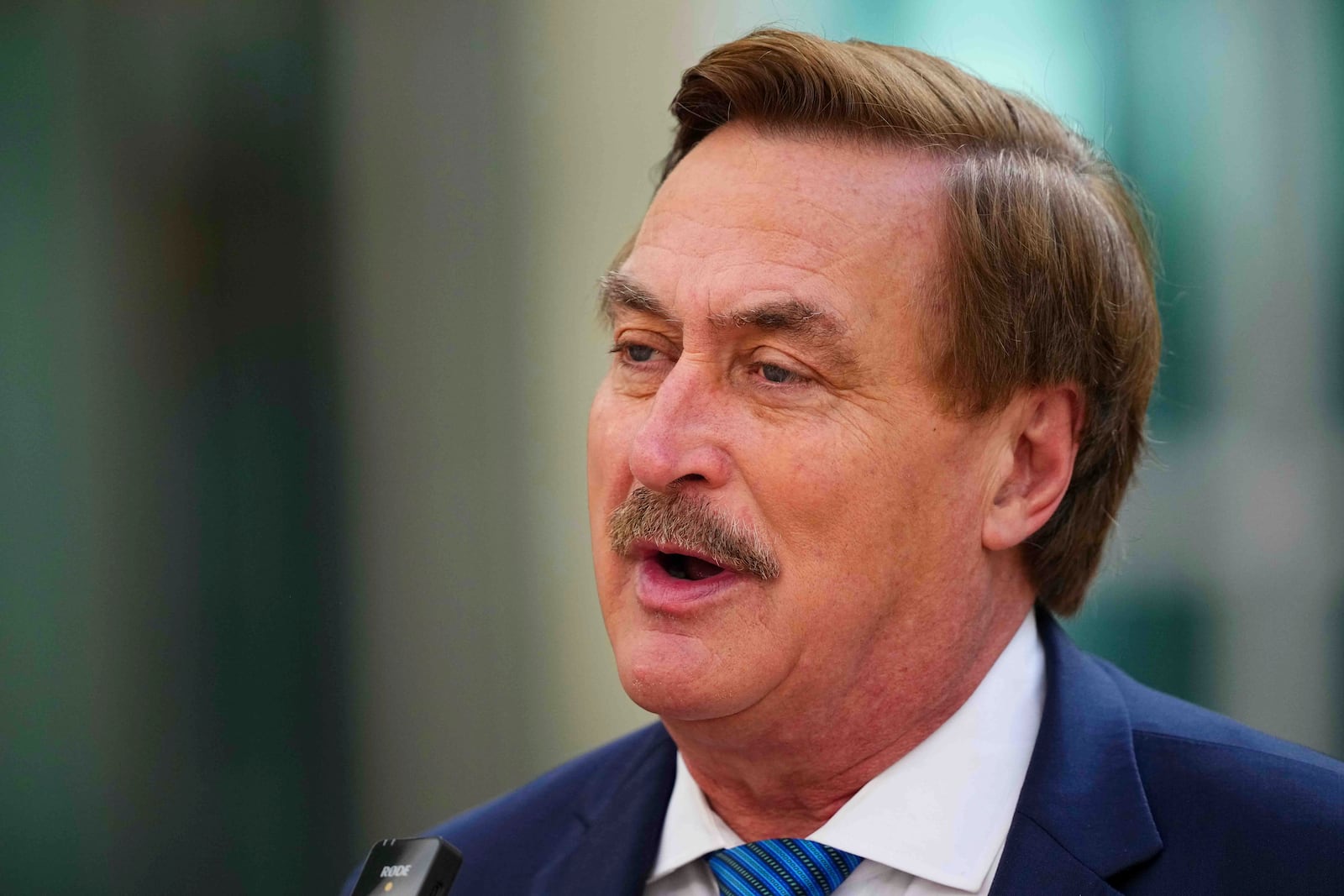 Mike Lindell talks to the media on his way into federal district court for a defamation trial on Thursday, June 5, 2025, in Denver. (AP Photo/Jack Dempsey)
