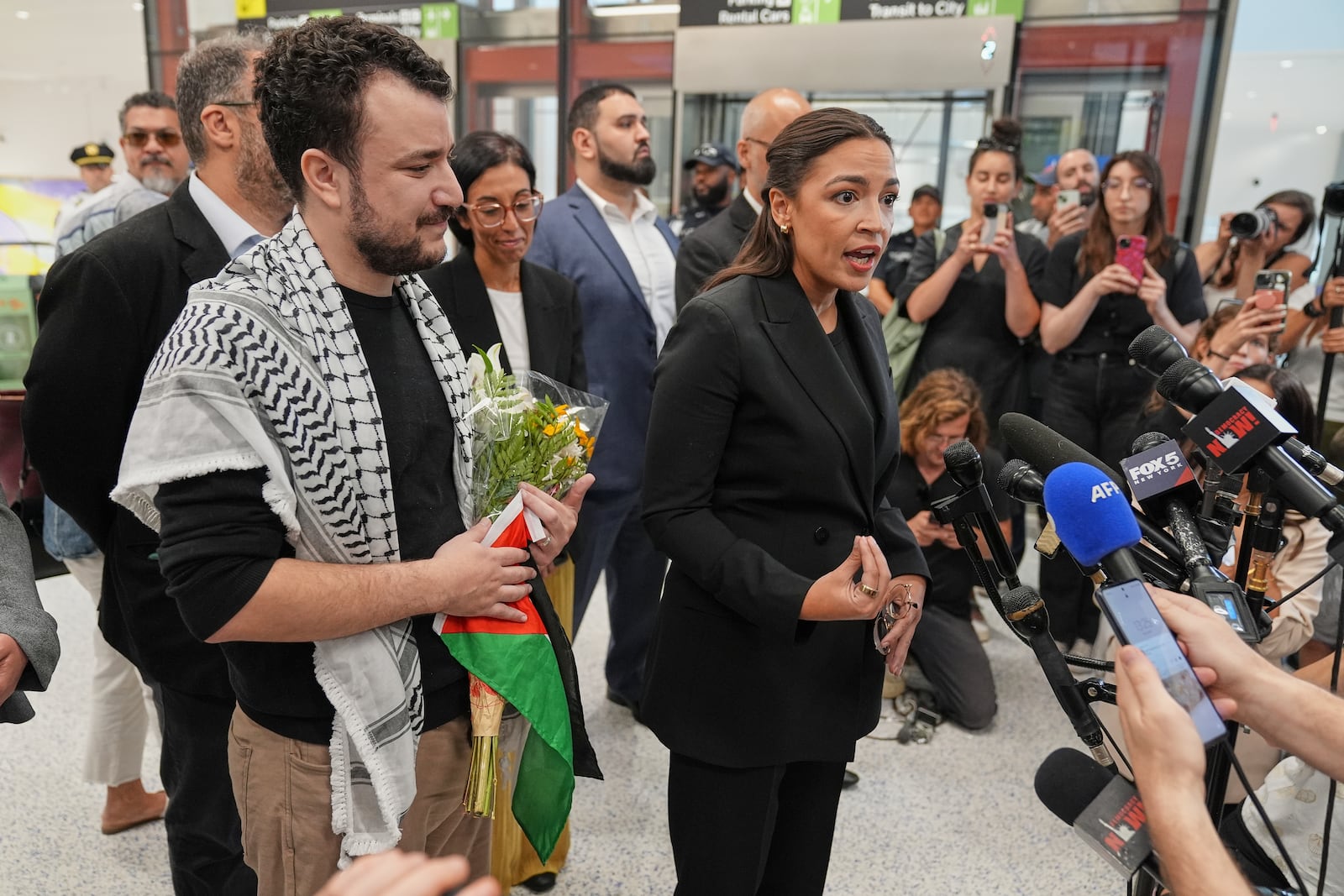 Rep. Alexandria Ocasio-Cortez, D-N.Y., speaks during a news conference after Mahmoud Khalil, left, arrived at Newark International Airport, Saturday, June 21, 2025, in Newark, N.J. (AP Photo/Seth Wenig)