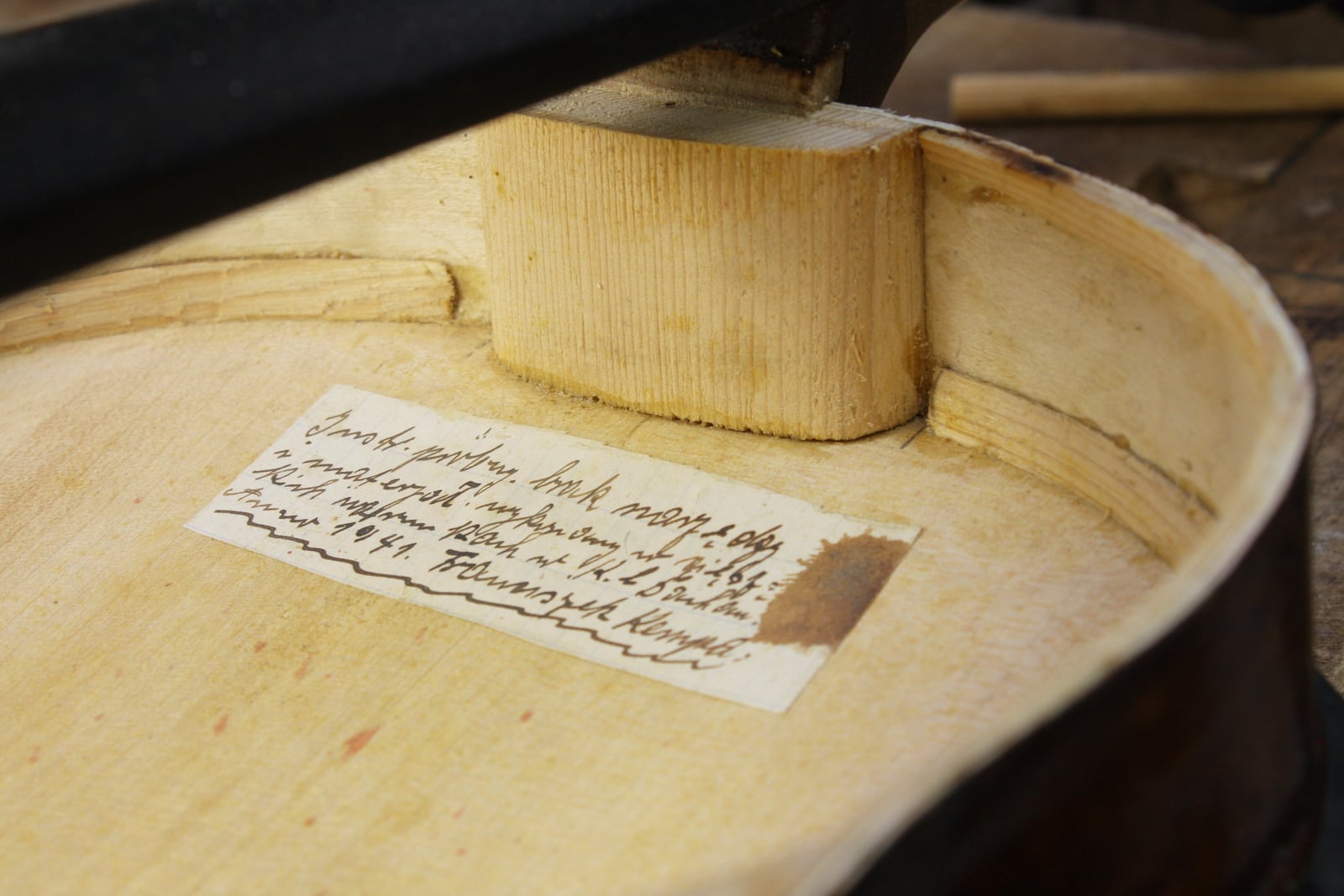 A handwritten and hidden tag in Silesian dialect (mix of Polish and German) inside a Dachau-build instrument dubbed the ''violin of hope'' reads: ''Trial instrument, made under difficult conditions with no tools and materials, K. L. Dachau. Anno 1941, Franciszek Kempa'', in Magyarpolány, Hungary, Tuesday September 8, 2020. (Szandra Katona via AP)