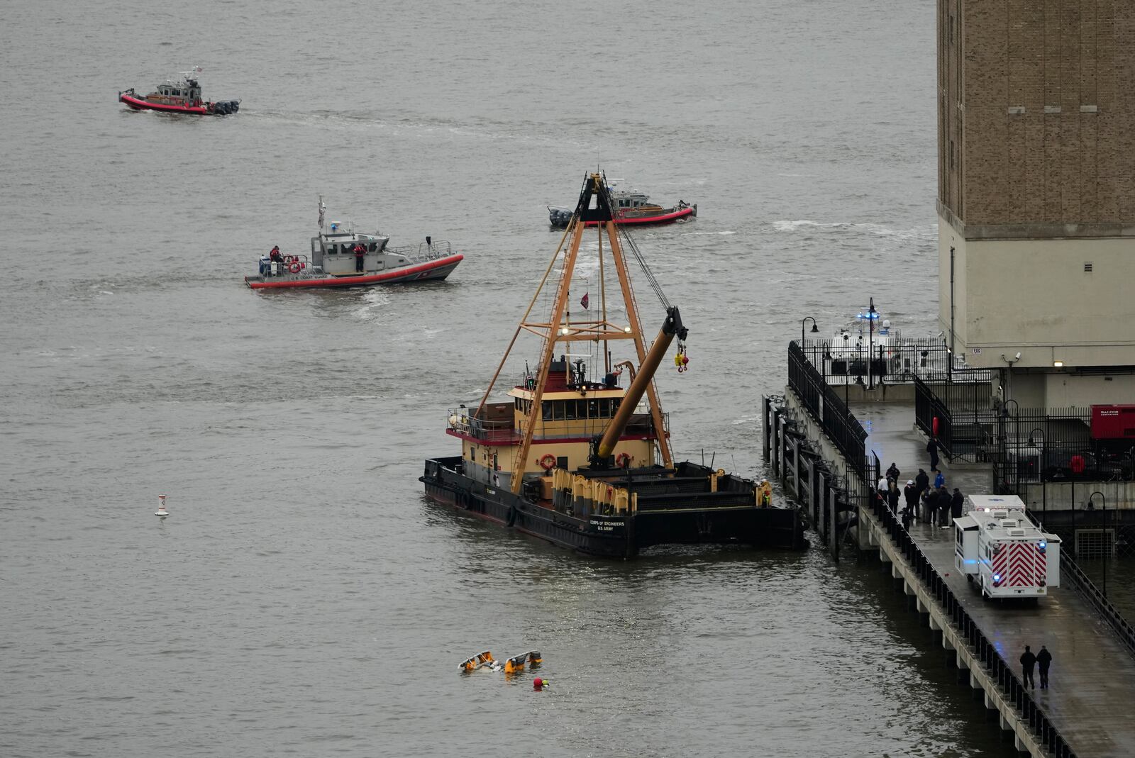 A crane vessel arrives at the scene where a helicopter crashed into the Hudson River, Thursday, April 10, 2025, in Jersey City, N.J. (AP Photo/Seth Wenig)
