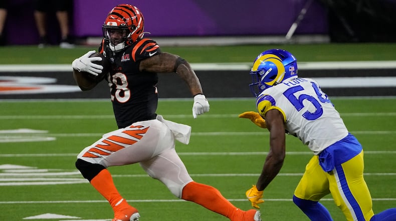 Cincinnati Bengals running back Joe Mixon (28) runs near Los Angeles Rams outside linebacker Leonard Floyd (54) during the second half of the NFL Super Bowl 56 football game Sunday, Feb. 13, 2022, in Inglewood, Calif. (AP Photo/Tony Gutierrez)