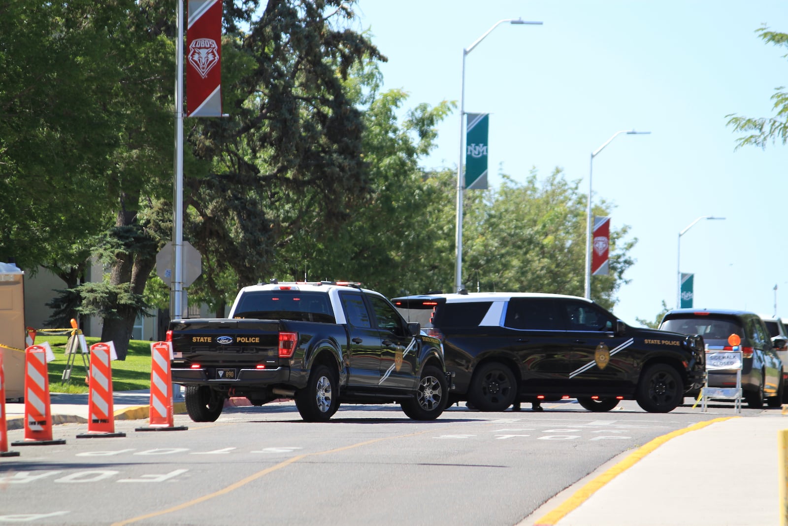 Authorities block access to an area on the University of New Mexico campus where two people were shot, one fatally, in the early morning hours in Albuquerque, N.M., on Friday, July 25, 2025. (AP Photo/Susan Montoya Bryan)