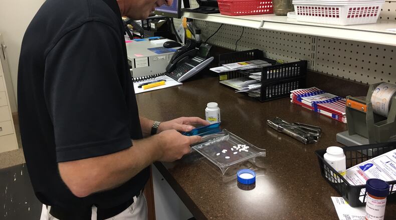 Pharmacist Bob Curlis works at Sidney Hometown Pharmacy in Sidney, Aug. 29, 2017.