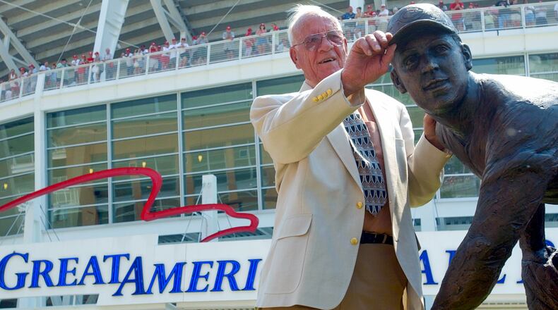 Joe Nuxhall tugs on the bill of the cap of the statue dedicated in his honor at Great American Ballpark, before the Cincinnati Reds vs Astro' game July 20, 2003. TONY TRIBBLE/JOURNALNEWS