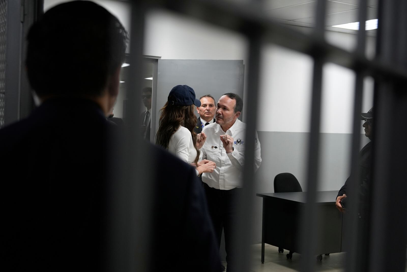 Minister of Justice and Public Security Héctor Villatoro, right center, speaks to Homeland Security Secretary Kristi Noem as they begin their tour of the Terrorist Confinement Center in Tecoluca, El Salvador, Wednesday, March 26, 2025. (AP Photo/Alex Brandon)