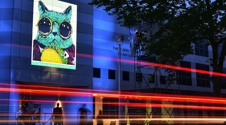 Artwork is projected on the outside of Fitton Center for Creative Arts along Monument Street for the 50th anniversary Hamilton Current regional art competition. The art will be on display from 8 p.m. until midnight starting Friday, May 28 for the week-long public art display. This is Taco Cat by artist Brian Beck. NICK GRAHAM / STAFF