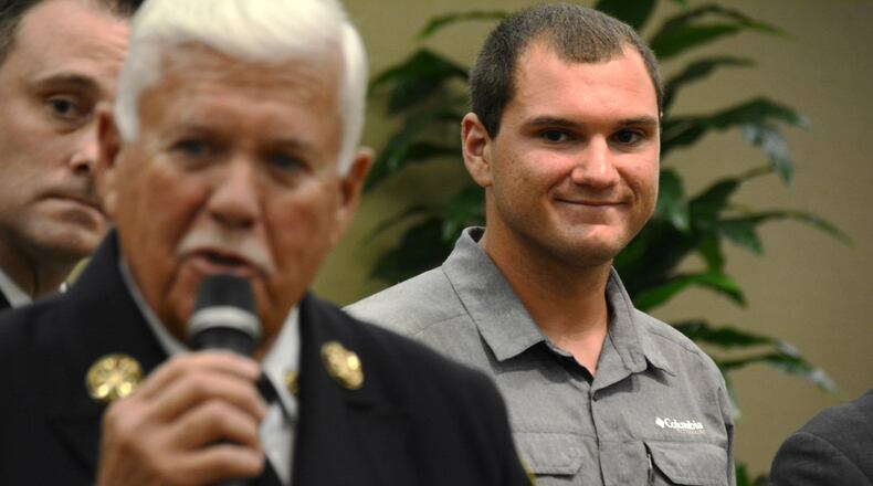 Tyler Tacy was honored Tuesday, Oct. 9, 2018, by the city of Fairfield for helping to save his father, Steve, after he was electrocuted at his warehouse on Le Saint Drive in July. Tyler, 21, called 911 and gave CPR to his father at the instruction of the 911 operator, Tracy Brown, until medical personnel arrived. Oct. 10, 2018, was proclaimed Tyler Tacy day in the city of Fairfield. Tyler Tacy listens to Fairfield Fire Chief Don Bennett as he talks about that day. MICHAEL D. PITMAN/STAFF