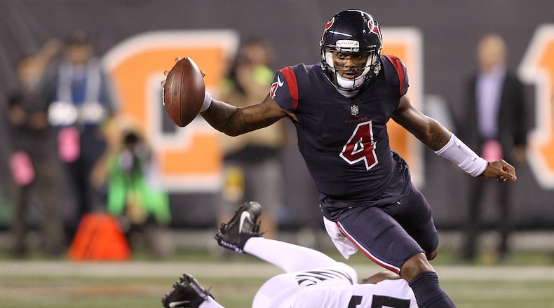 CINCINNATI, OH - SEPTEMBER 14: Deshaun Watson #4 of the Houston Texans breaks a tackle from Carl Lawson #58 of the Cincinnati Bengals as he runs for a touchdown during the first half at Paul Brown Stadium on September 14, 2017 in Cincinnati, Ohio. (Photo by John Grieshop/Getty Images)