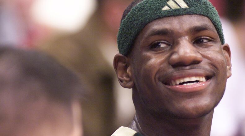 LeBron James smiles to the crowd as he sits on the St.Vincent-St.Mary bench with a minute left in the game. James scored 32 points against Poland Seminary in the Division II semifinal basketball game in March, 2002. DDN FILE