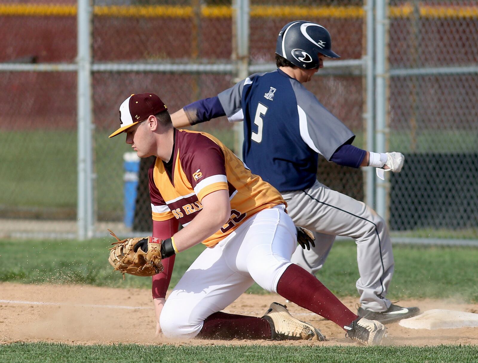Edgewood base runner Cole Craft gets safely back to first as Ross first baseman Logan Fuller tries to apply the tag during their game at Ross on Wednesday. CONTRIBUTED PHOTO BY E.L. HUBBARD