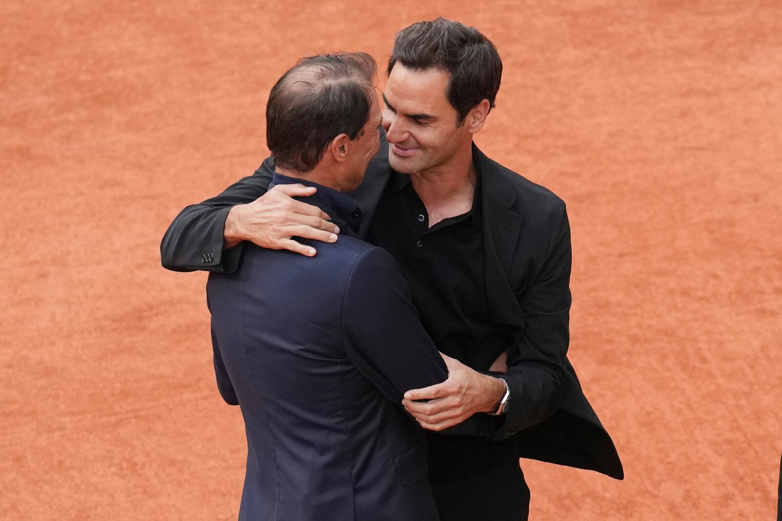 Rafa Nadal, left, hugs Roger Federer, during a farewell ceremony at center court Philippe-Chatrier, at the Roland-Garros stadium, in Paris, Sunday May 25, 2025. (AP Photo/Christophe Ena)