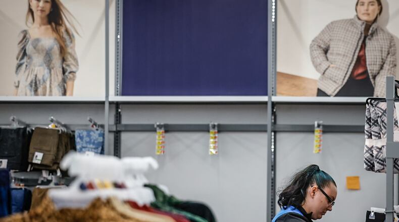 Beavercreek Walmart team associate, Kelly Sallee restocks shelves at the store Monday, Nov., 14, 2022. Holiday shopping is expected to increased by 3.4% in Ohio this year and over 5% in the Dayton region. JIM NOELKER/STAFF