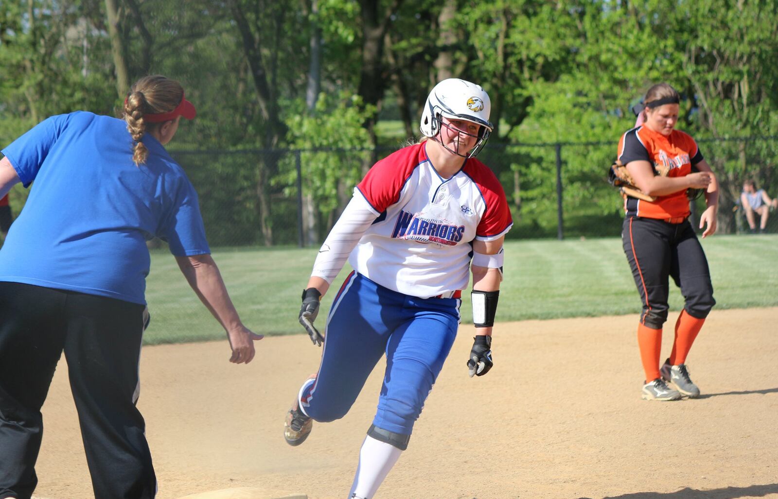 Northwestern coach Missy Johnson congratulates junior Jenna Robbins after Robbins hit a three-run homer Monday against Arcanum. Greg Billing/Contributed photo