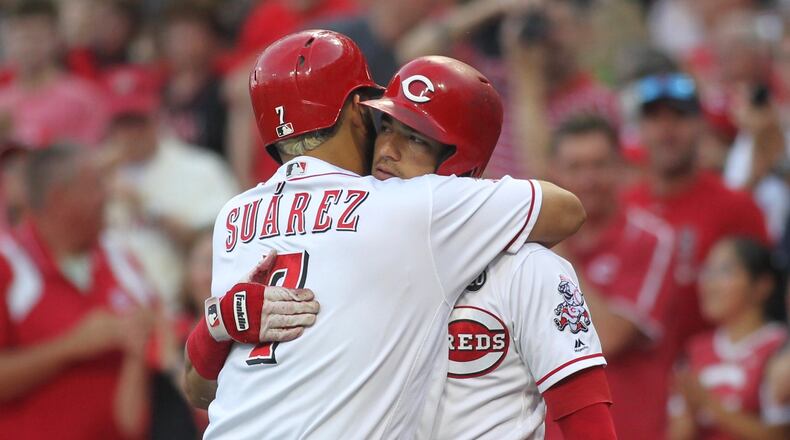 Eugenio Suarez and Jose Iglesias hug after Suarez hit a solo home run in the first inning against the Angels on Tuesday, Aug. 6, 2019, at Great American Ball Park in Cincinnati.