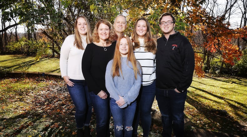 Ed and Holly Schlaack, who have 3 adult children, are adopting 12-year-old Paige, middle, on National Adoption Day after 3-years of being foster parents Saturday, Nov. 20 at the historic Butler County Courthouse in Hamilton. The Schlaacks are pictured left to right; Hanna, Holly, Ed, Paige, Grace and Ben. NICK GRAHAM / STAFF
