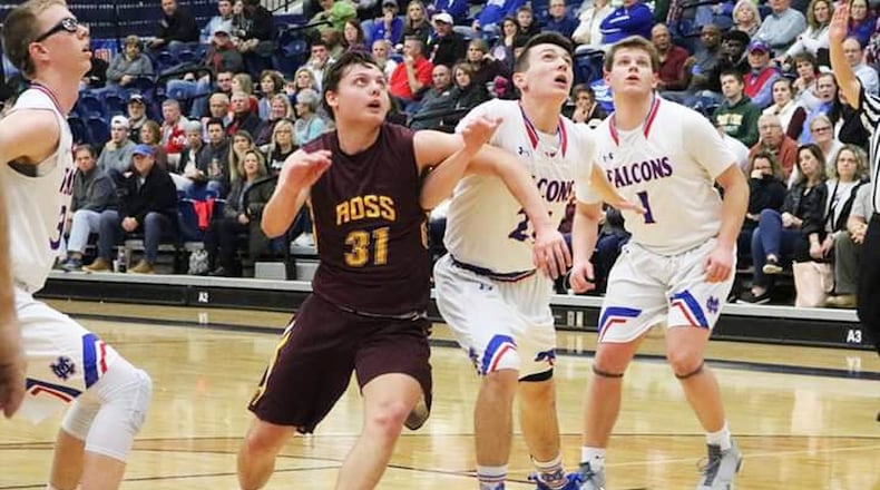 Sean Lange of Ross battles Clinton-Massie’s Nate Baker (21) for rebounding position during Friday night’s Division II sectional basketball game at Fairmont’s Trent Arena in Kettering. Clinton-Massie won 61-54 in overtime. CONTRIBUTED PHOTO BY TERRI ADAMS