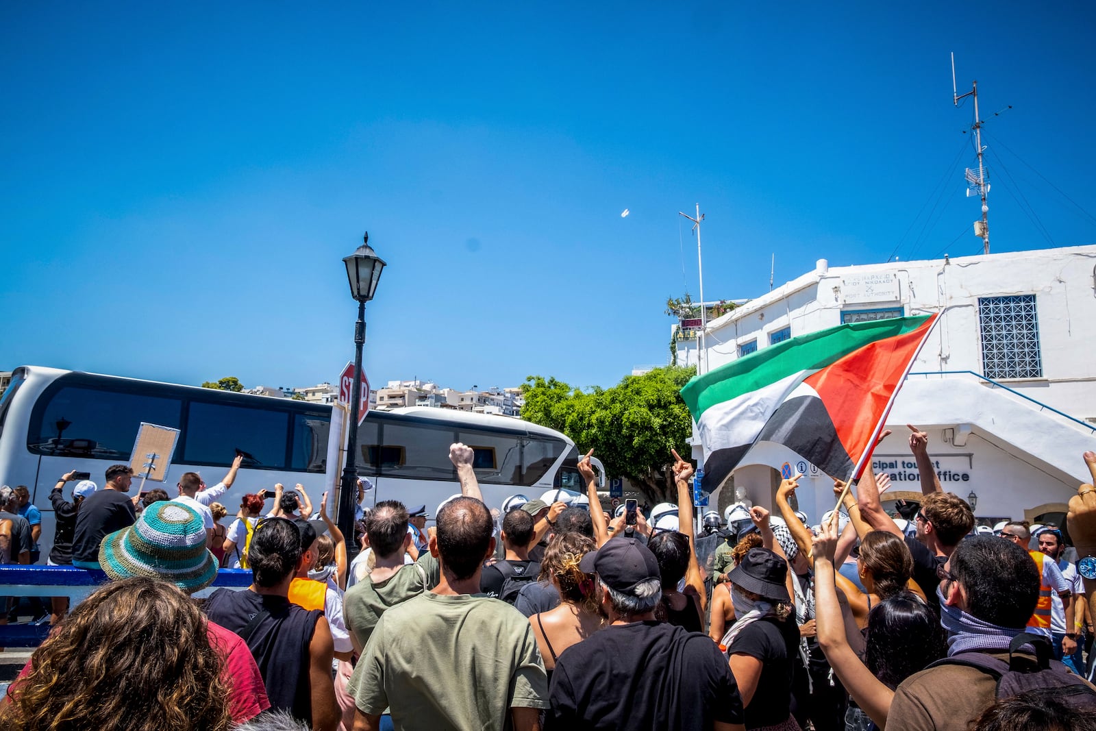 EDS NOTE: OBSCENITY - Pro-Palestinian protesters react as a coach carrying Israeli tourists leave the port after the arrival of a cruise ship, in Agios Nikolaos, on the island of Crete, Greece, Tuesday, July 29, 2025. (Antonis Zouridakis/Eurokinissi via AP)