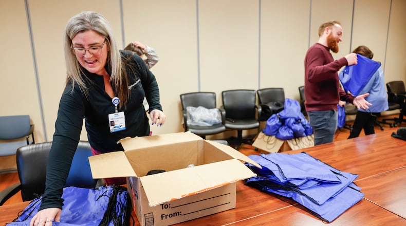 Gloria Nichols is the new Substance Use Navigator (SUN) at Atrium Medical Center in Middletown. Partnering with the Butler County General Health District for three years of funding support has made this possible. The SUN will meet with patients in Atrium’s Emergency Department and across inpatient units who are struggling with addiction with the goal to coordinate a plan for treatment and help them toward recovery. A group packed backpacks with blankets, socks, hygiene supplies to give to patients as part of the program. NICK GRAHAM/STAFF