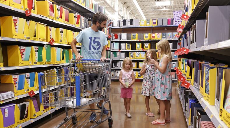 Zack Hinger shops for school supplies with daughters Lily, 8, Theresa, 6, and Cece, 4, at Walmart Tuesday, July 23, 2024 in West Chester Twp. Ohio's 2025 sales tax holiday will run for two full weeks, kicking off at midnight Aug. 1 and ending at 11:59 p.m. Aug. 14. NICK GRAHAM/STAFF