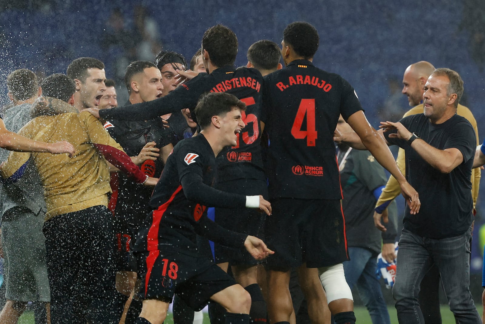 Barcelona players celebrate at the end of the Spanish La Liga soccer match between Barcelona and Espanyol at Lluis Companys Olympic Stadium in Barcelona, Spain, Thursday, May 15, 2025. (AP Photo/Joan Monfort)