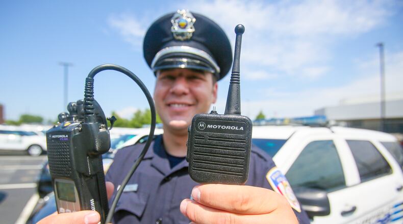 Fairfield Police officer Scott Webb displays his radio outside the police station, Wednesday, Aug. 2. Butler County officials and police and fire departments across the county are looking at a $19.2 million price tag to replace parts of the 800 MHz communications systems, including the radios first responders carry.GREG LYNCH / STAFF