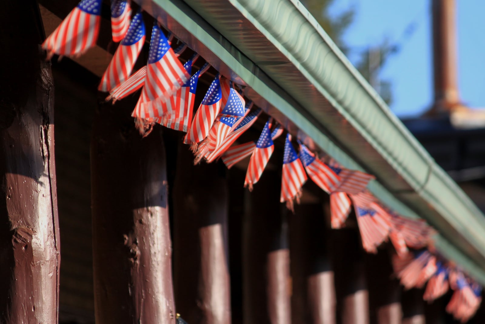 Dozens of tiny American flags line the entrance to the Western Drug and General Store in Springerville, Ariz., Tuesday, April 22, 2025. (AP Photo/Susan Montoya Bryan)