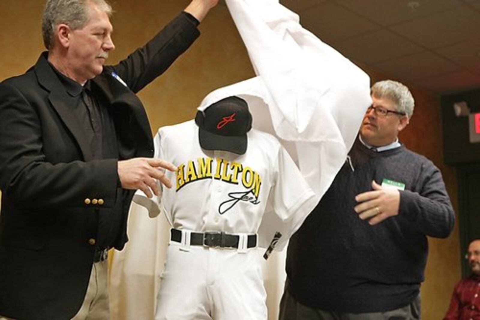 Coach Darrel Grissom [left] and Dr. Kim Lance unveil the uniforms that will be worn by the Hamilton Joes Baseball Club during a press conference at Ryan's Tavern in Hamilton, Saturdaym February 14, 2009.