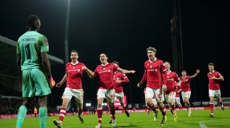 FILE - Wrexham's goalkeeper Arthur Okonkwo, left, celebrates with teammates after a penalty shootout at the end of the English FA Cup third round soccer match between Wrexham and Nottingham Forest in Wrexham, Wales, Friday, Jan. 9, 2026. (AP Photo/Jon Super, File)