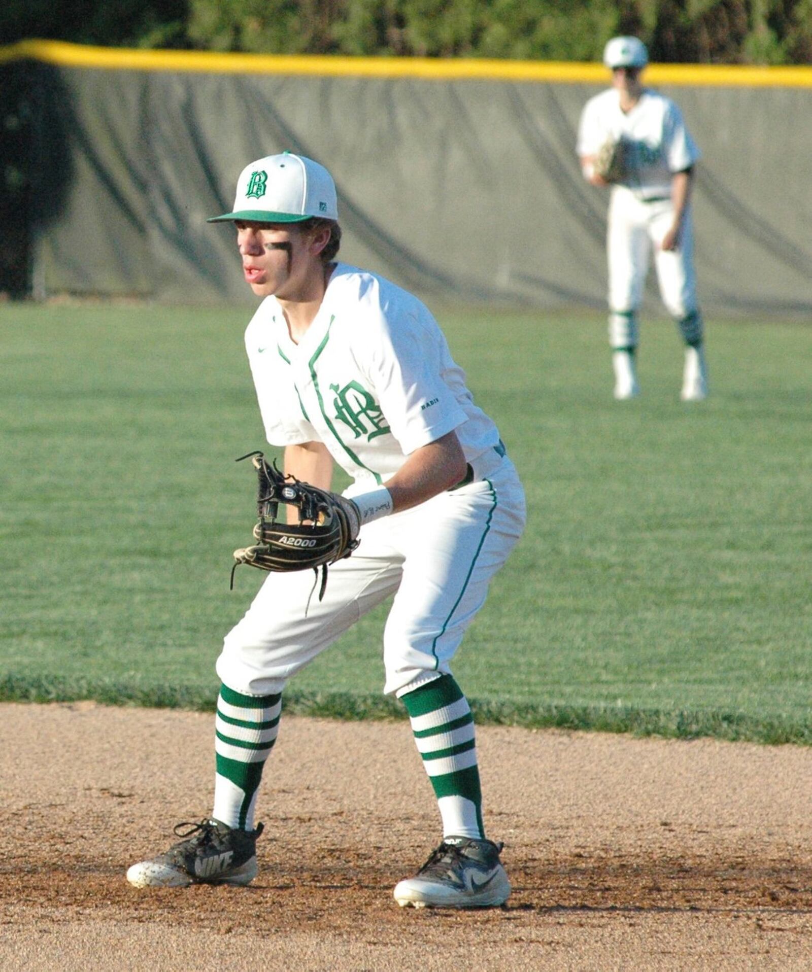 Badin second baseman A.J. Enginger takes a defensive position Monday night during a Butler County baseball game against visiting Ross at Alumni Field at Joyce Park. Badin won 6-2. RICK CASSANO/STAFF