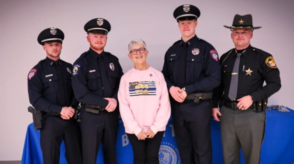 Denise Dulle, mother of deceased Warren County Sheriff Deputy Brian Dulle, poses with this year's memorial fund winners. L-R are Officer Evan Planck, Miamisburg Police Department; Officer Michael Lyon, West Carrollton Police; Officer Aaron Dufresne, Miamisburg Police and Deputy Matthew Garrett, Brown County Sheriff's Office. CONTRIBUTED