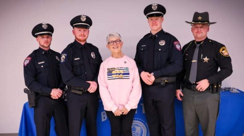 Denise Dulle, mother of deceased Warren County Sheriff Deputy Brian Dulle, poses with this year's memorial fund winners. L-R are Officer Evan Planck, Miamisburg Police Department; Officer Michael Lyon, West Carrollton Police; Officer Aaron Dufresne, Miamisburg Police and Deputy Matthew Garrett, Brown County Sheriff's Office. CONTRIBUTED