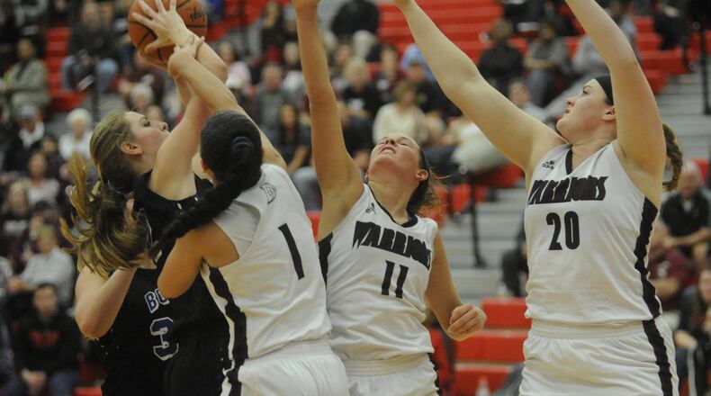 Springboro’s Lauren Thomas (with ball) draws Lebanon defenders Alexis Straw (1), Ashley West (11) and Cassidy Osborne during a Division I sectional final at Troy on Feb. 24, 2017. MARC PENDLETON/STAFF
