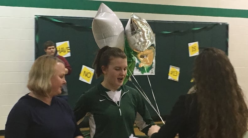 New Miami’s Samantha Jones (middle) is greeted by Vikings coach Ashley Rison during a Senior Night ceremony before Wednesday’s game against visiting Lockland. Jones is New Miami’s lone senior. RICK CASSANO/STAFF