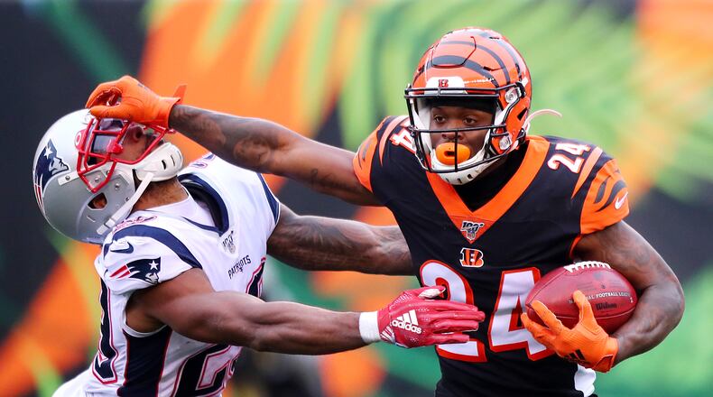 CINCINNATI, OHIO - DECEMBER 15: Darius Phillips #24 of the Cincinnati Bengals stiff arms Justin Bethel #29 of the New England Patriots on a kickoff return during the second half in the game at Paul Brown Stadium on December 15, 2019 in Cincinnati, Ohio. (Photo by Bobby Ellis/Getty Images)