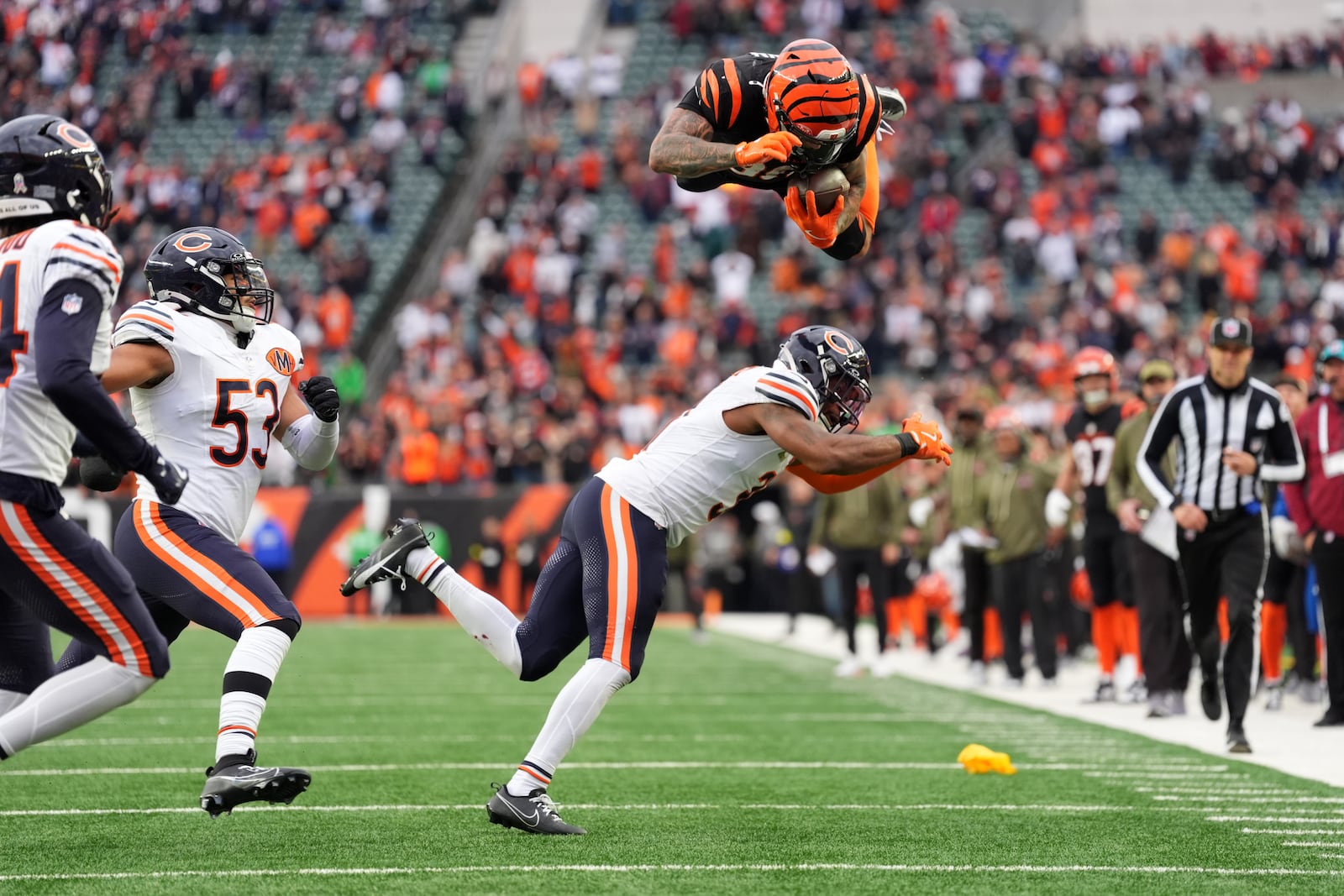 Cincinnati Bengals running back Chase Brown (30) hurdles Chicago Bears defensive back Kevin Byard III (31) on a run during an NFL football game, Sunday, Nov. 2, 2025, in Cincinnati. (AP Photo/Kareem Elgazzar)