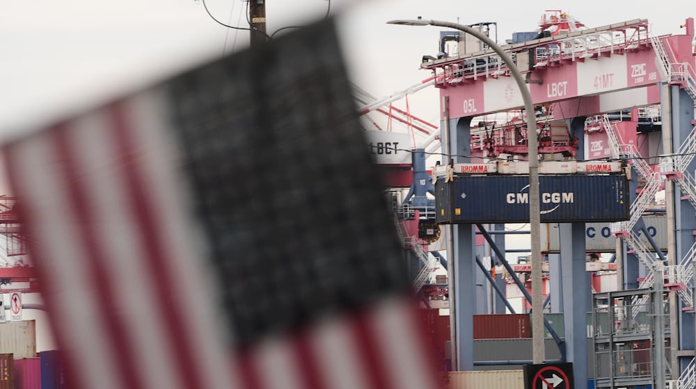 A U.S. flag files at the Port of Long Beach Friday, Feb. 20, 2026, in Long Beach, Calif. (AP Photo/Damian Dovarganes)