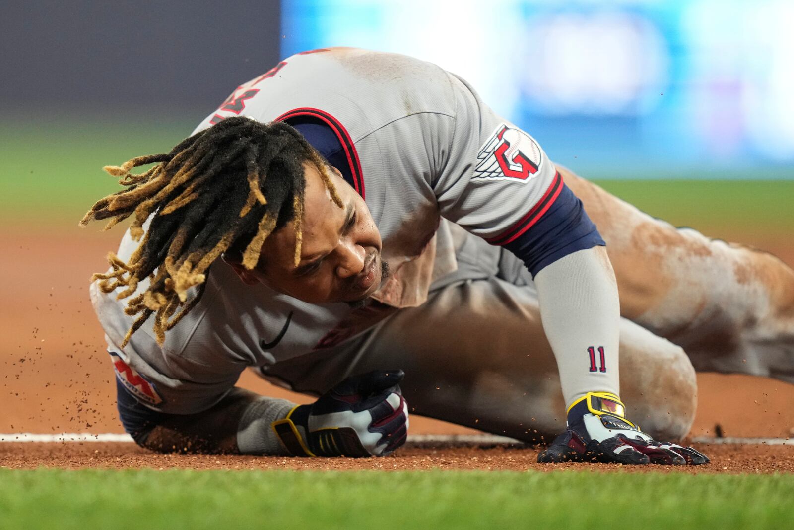 Cleveland Guardians' Jose Ramirez falls after reaching first base on a single against the Toronto Blue Jays during the third inning of a baseball game in Toronto on Friday, May 2, 2025. (Chris Young/The Canadian Press via AP)