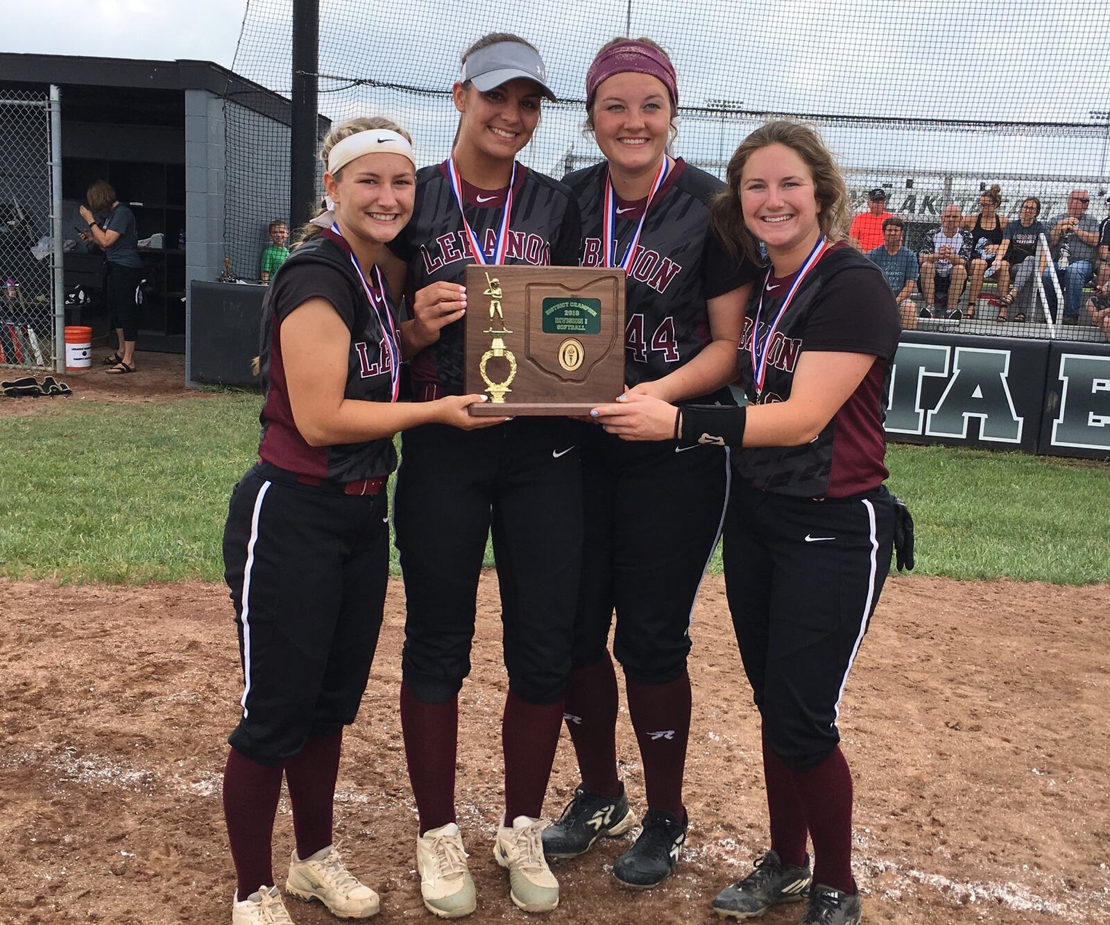 Lebanon seniors (from left) Molly Osborne, Madison Hartman, Cassidy Osborne and Madison DeGennaro pose with the Division I district championship trophy Saturday after a 5-1 win over Fairfield at Lakota East. RICK CASSANO/STAFF