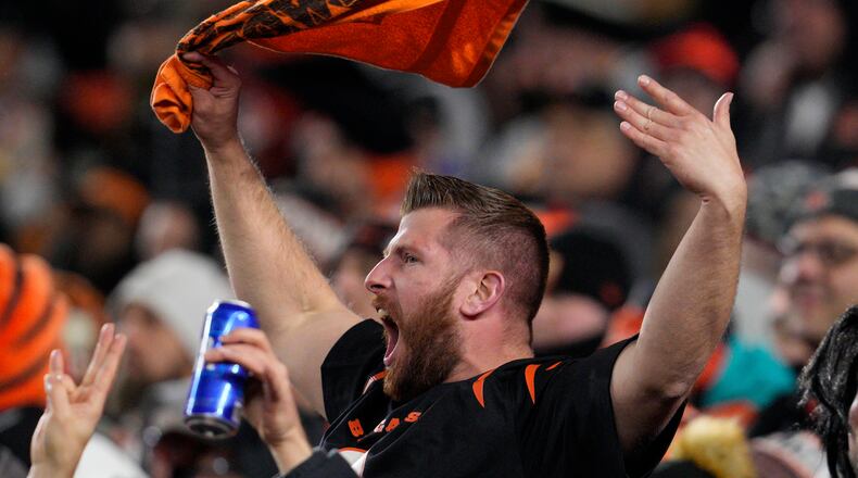 A fan cheers in the first half of an NFL wild-card playoff football game between the Baltimore Ravens and Cincinnati Bengals in Cincinnati, Sunday, Jan. 15, 2023. (AP Photo/Jeff Dean)