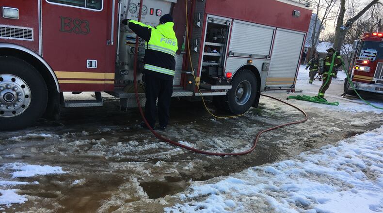 Middletown firefighters fought a fire Tuesday morning on Young Street despite the dangerous icy and snow conditions. RICK McCRABB/STAFF
