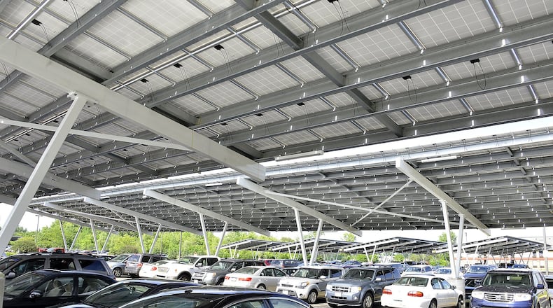 With use of solar power growing nationwide, Hamilton utility officials on Wednesday will hold a public input session on whether to purchase solar power from residents. Businesses are invited to attend as well. In this photo, the Assurant company has more than 6,000 solar panels at its Springfield location, with its parking lot covered by a series of carports topped by solar panels. BILL LACKEY/STAFF 2015