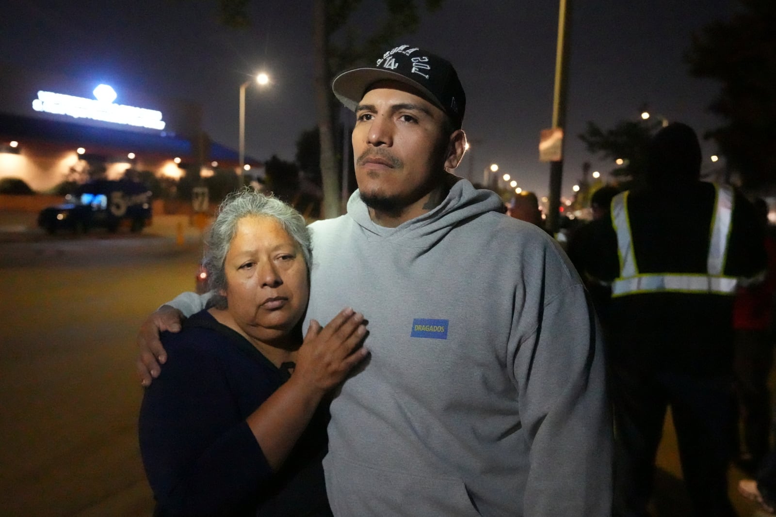 Maria Orozco hugs her son, Oraldo Orozco, one of her three sons who were trapped as tunnel workers inside a collapsed tunnel under construction for Los Angeles County's Clean Water project, Wednesday, July 9, 2025, in Los Angeles. (AP Photo/Damian Dovarganes)