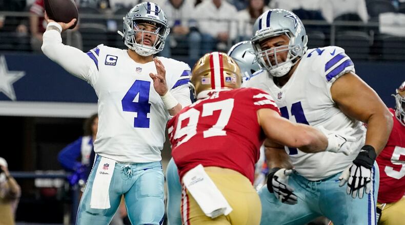 Dallas Cowboys quarterback Dak Prescott (4) throws a pass as offensive tackle La'el Collins (71) helps against pressure from San Francisco 49ers defensive end Nick Bosa (97) in the first half of an NFL wild-card playoff football game in Arlington, Texas, Sunday, Jan. 16, 2022. (AP Photo/Tony Gutierrez)