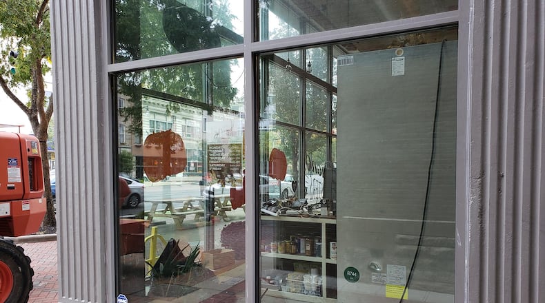A broken window was replace dat the Almond Sister business in Hamilton in late October 2020. NICK GRAHAM / STAFF