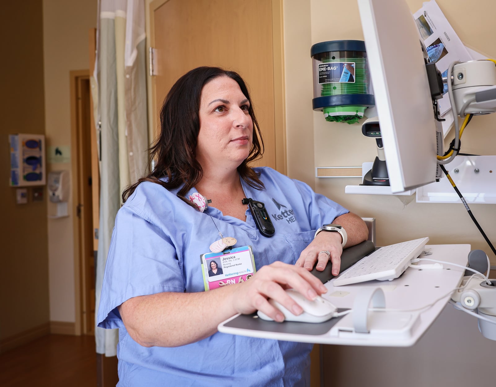 Jessica Katawick, a labor and delivery nurse for Kettering Health, works on a computer at Soin Medical Center in Beavercreek on Thursday, Oct. 2. Katawick said before Herceptin, a brand-name medication for the drug trastuzumab, a breast cancer diagnosis was more of a "doomsday scenario." BRYANT BILLING / STAFF