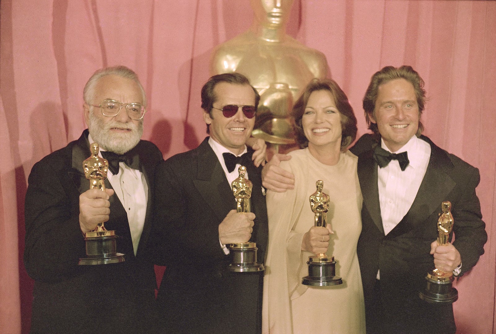FILE - Members of the cast and crew of "One Flew Over the Cuckoo's Nest," winners of the Oscars for best director, best actor, best actress and best picture, from left, director Milos Forman, actor Jack Nicholson, actress Louise Fletcher and co-producer Michael Douglas, are shown at the Oscars on March 30, 1976. (AP Photo, File)