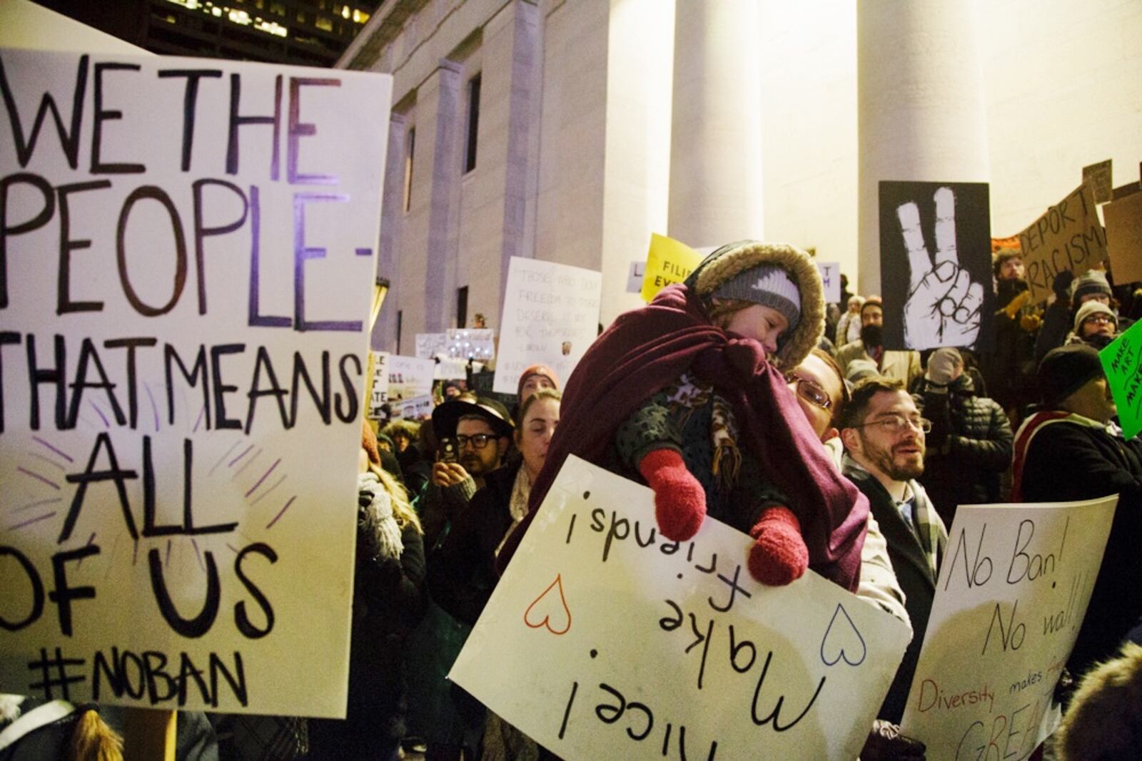 More than 1,000 people, carrying signs and singing protest songs against President Trump's executive order banning travel, marched Monday night at the Statehouse in Columbus. (Courtesy/Annie Noelker)