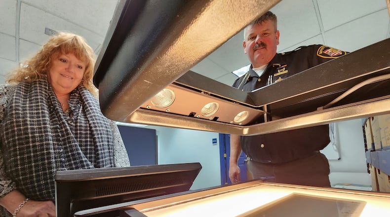 Tammy Winkler, site administrator for Combined Public Communications, left and Butler County Sheriff's Office Capt. Nick Fisher demonstrate how legal mail is checked for contraband prior to being given to inmates at Butler County jail in Hamilton. Copies are made of regular letters to be given to inmates. NICK GRAHAM/STAFF